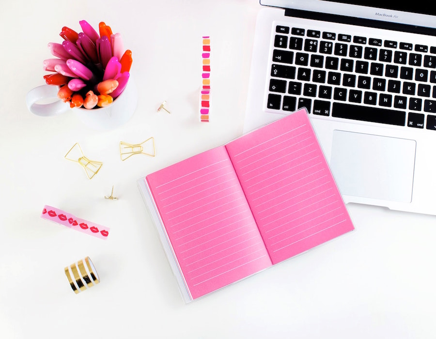 Top down photo of desk with work accessories