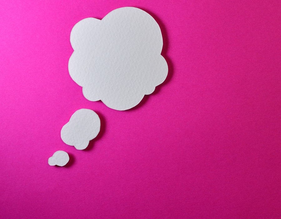 White idea bubbles on pink background