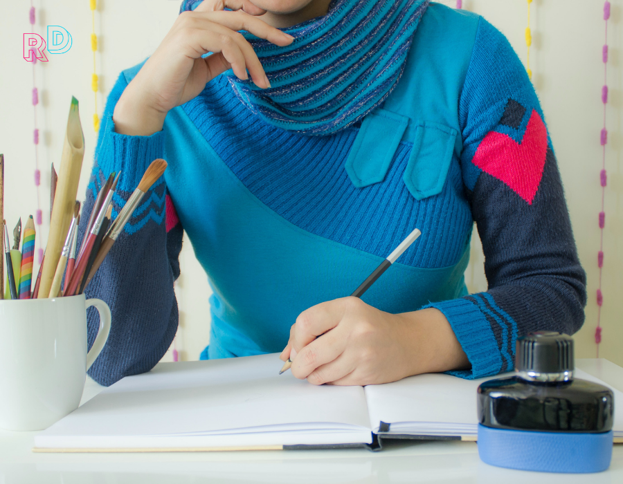 Women with heart on her sleeve writing in a notebook