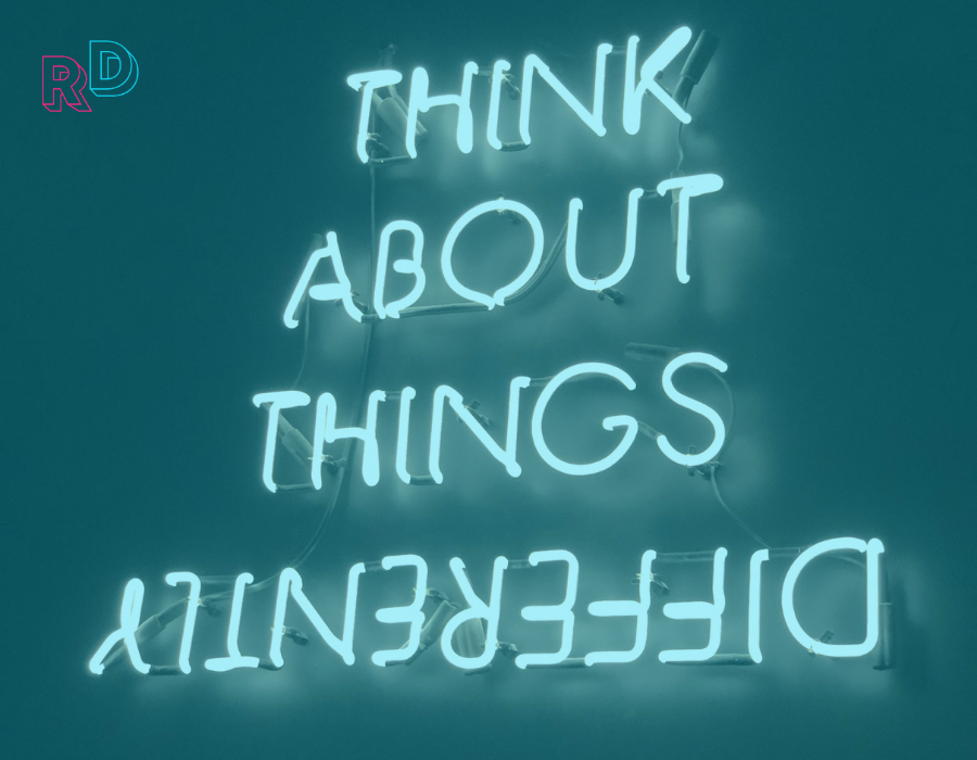 Neon sign that says think about things differently